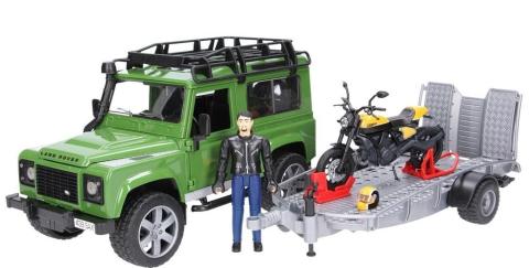 Land Rover Defender z przyczepą i motocyklem